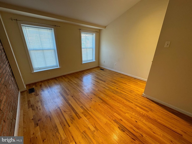 1637 Fleet St, Baltimore, MD 21231 - unfurnished room with lofted ceiling, visible vents, baseboards, and wood finished floors