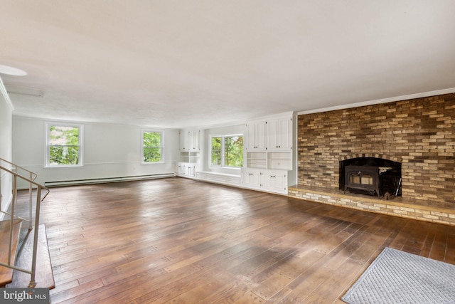 5936 River Dr, Lorton, VA 22079 - unfurnished living room featuring dark wood-type flooring, baseboard heating, stairs, and a wood stove
