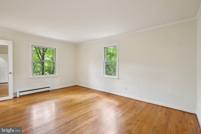 5936 River Dr, Lorton, VA 22079 - spare room featuring baseboard heating, plenty of natural light, wood finished floors, ornamental molding, and baseboards