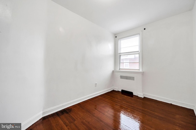 6846 Radbourne Rd, Upper Darby, PA 19082 - spare room with baseboards, radiator heating unit, and hardwood / wood-style floors