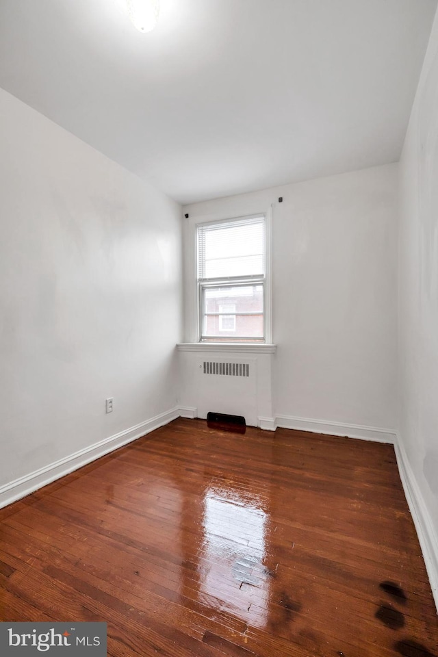 6846 Radbourne Rd, Upper Darby, PA 19082 - spare room with baseboards, radiator heating unit, and hardwood / wood-style flooring