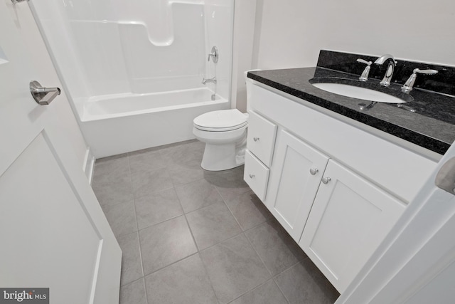 full bath featuring toilet, tile patterned flooring, vanity, and shower / washtub combination