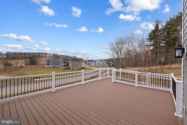 wooden terrace with a lawn and a residential view