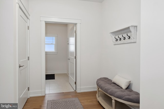 mudroom featuring wood finished floors and baseboards