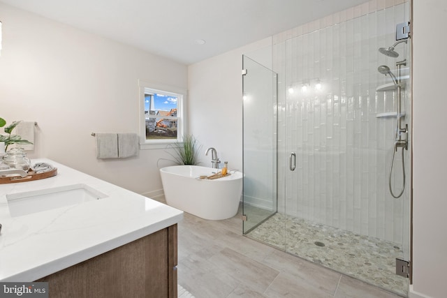 full bath featuring a freestanding bath, vanity, and a stall shower