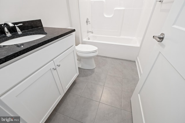 full bath featuring tile patterned flooring, toilet, bathing tub / shower combination, and vanity