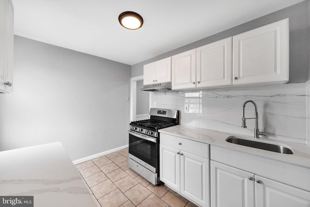 kitchen with a sink, stainless steel gas range, white cabinetry, tasteful backsplash, and under cabinet range hood