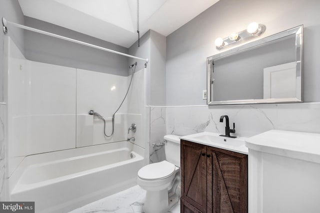 full bath featuring tile walls, marble finish floor, toilet, vanity, and shower / tub combination