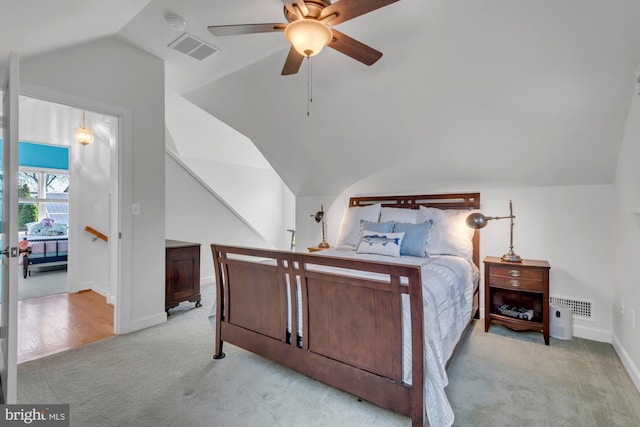 bedroom featuring visible vents, baseboards, vaulted ceiling, and carpet floors