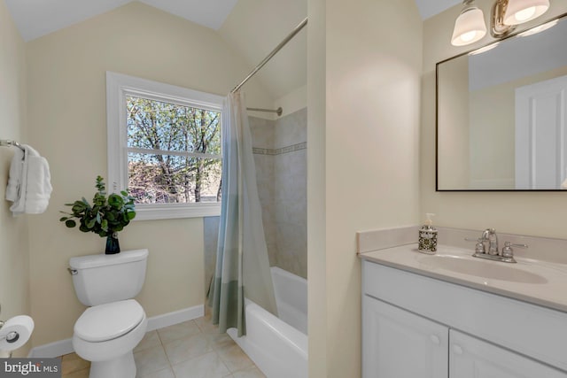 bathroom with baseboards, toilet, vanity, vaulted ceiling, and tile patterned flooring