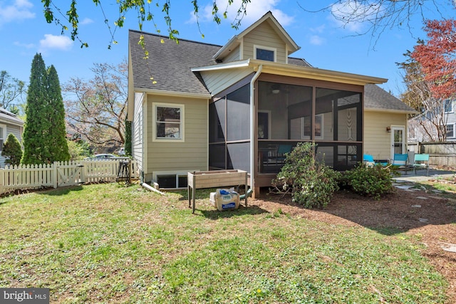 back of property with a yard, a fenced backyard, a sunroom, and roof with shingles