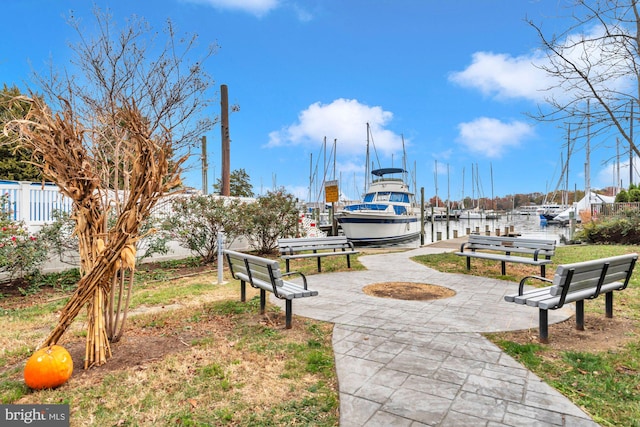 view of home's community with a water view and a boat dock