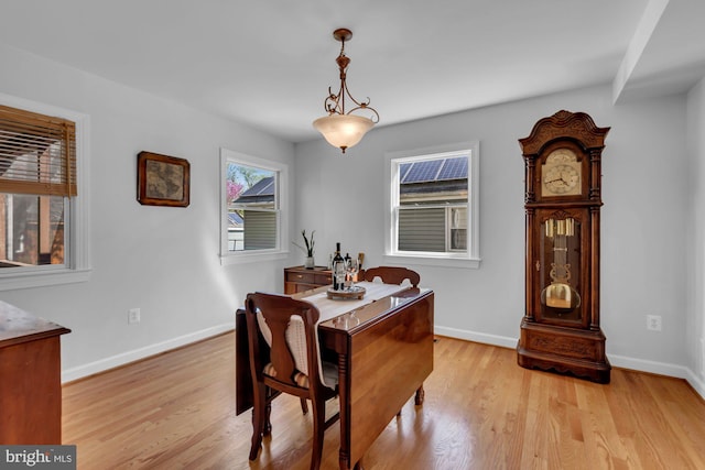 dining room featuring light wood-type flooring and baseboards