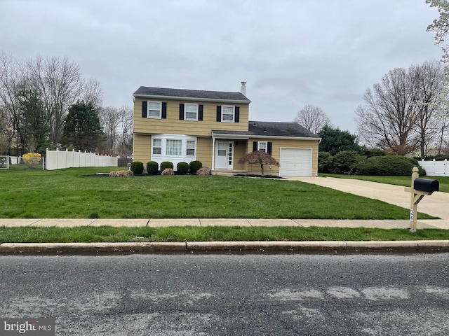 24 Elm Dr, Hightstown, NJ 08520 - traditional home featuring concrete driveway, a garage, a front yard, and fence
