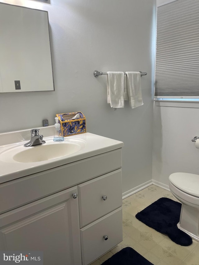 24 Elm Dr, Hightstown, NJ 08520 - bathroom with toilet, vanity, and baseboards