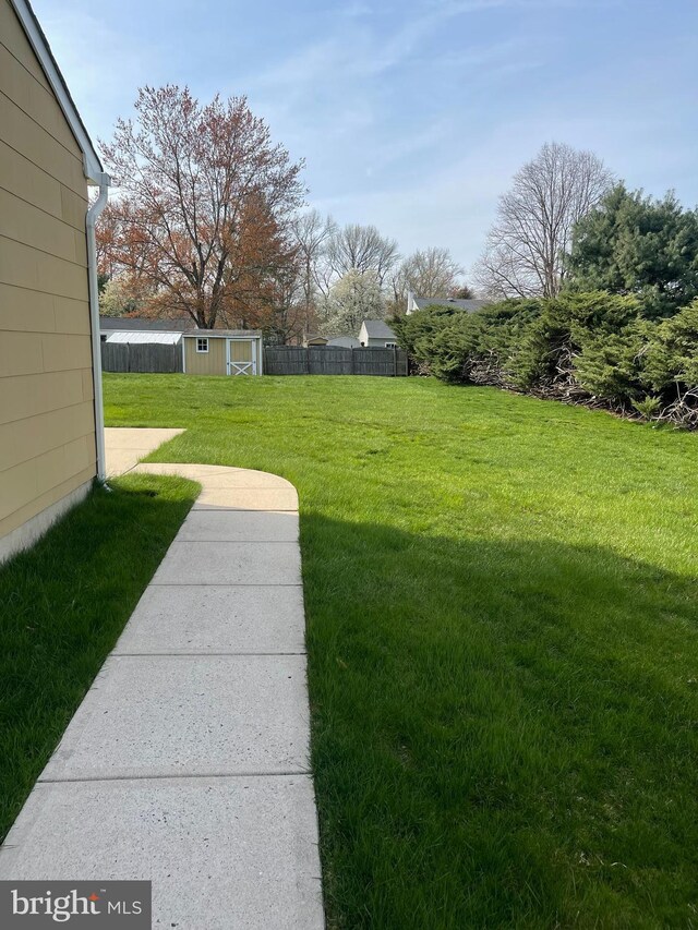 24 Elm Dr, Hightstown, NJ 08520 - view of yard with a storage shed, an outdoor structure, and fence