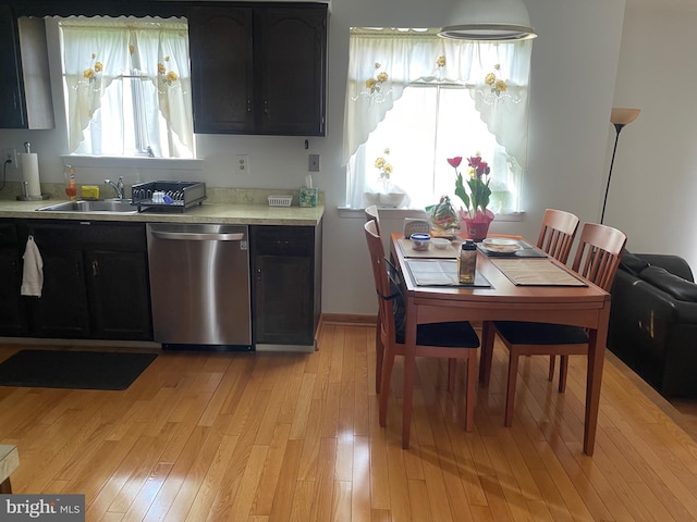 24 Elm Dr, Hightstown, NJ 08520 - kitchen with light wood-style floors, dark cabinets, dishwasher, light countertops, and a sink