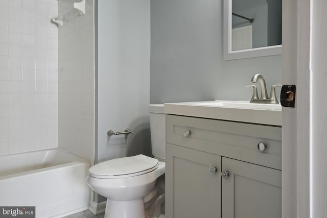 bathroom with bathing tub / shower combination, vanity, and toilet