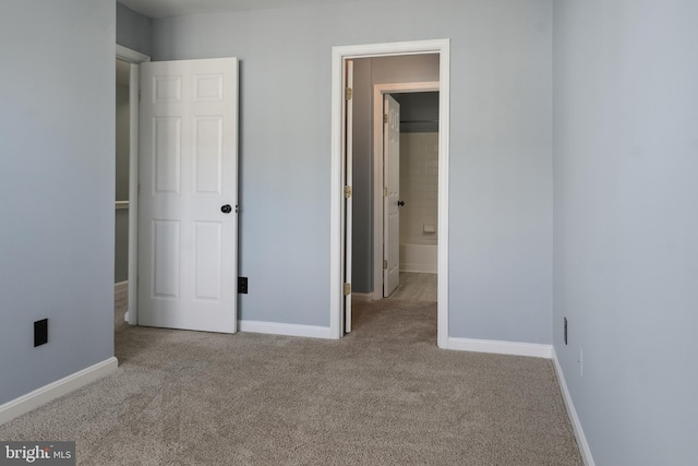 unfurnished bedroom featuring baseboards and carpet