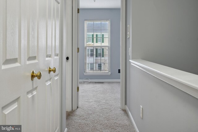 corridor featuring carpet and baseboards