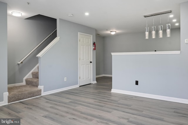 interior space featuring baseboards, wood finished floors, and recessed lighting
