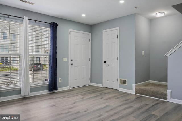 entrance foyer with baseboards, wood finished floors, visible vents, and recessed lighting