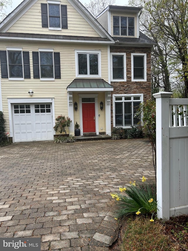 2656 Queen Anne Cir, Annapolis, MD 21403 - view of front facade featuring a garage, stone siding, and decorative driveway