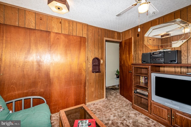 40 Dogwood Dr, Baltimore, MD 21220 - carpeted living area featuring wood walls, a textured ceiling, and ceiling fan