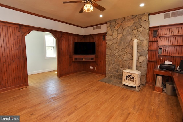 unfurnished living room featuring visible vents, wood finished floors, and ceiling fan