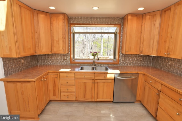 kitchen with decorative backsplash, dishwasher, recessed lighting, and a sink
