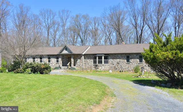 ranch-style home with a front lawn and stone siding