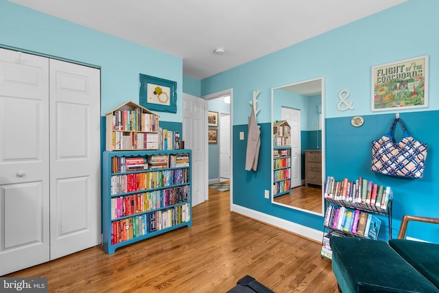 sitting room featuring baseboards and wood finished floors