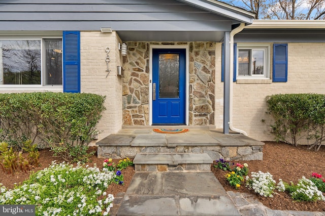 property entrance featuring brick siding