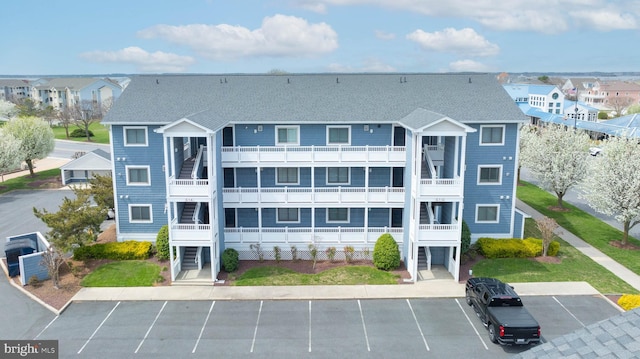 201 S Heron Dr Unit 1G, Harbour Club, Ocean City, MD 21842 - view of building exterior featuring a residential view and uncovered parking
