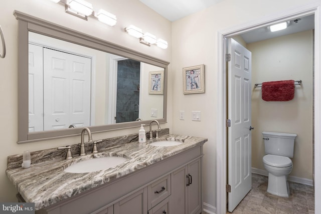 201 S Heron Dr Unit 1G, Harbour Club, Ocean City, MD 21842 - bathroom featuring toilet, a sink, double vanity, and baseboards