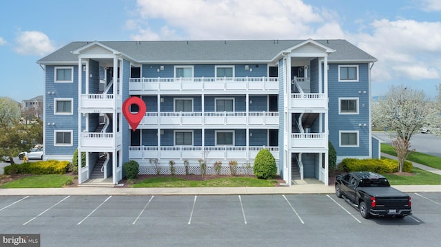 201 S Heron Dr Unit 1G, Harbour Club, Ocean City, MD 21842 - view of building exterior with stairway and uncovered parking