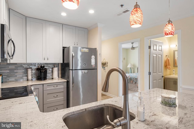 201 S Heron Dr Unit 1G, Harbour Club, Ocean City, MD 21842 - kitchen featuring a sink, appliances with stainless steel finishes, light stone counters, and visible vents