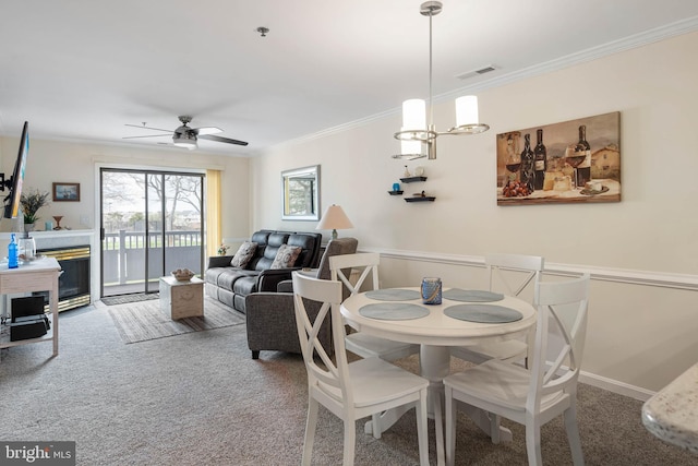 201 S Heron Dr Unit 1G, Harbour Club, Ocean City, MD 21842 - carpeted dining room featuring visible vents, ornamental molding, baseboards, and ceiling fan