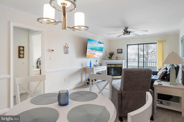 201 S Heron Dr Unit 1G, Harbour Club, Ocean City, MD 21842 - carpeted dining space featuring ceiling fan with notable chandelier, crown molding, and a glass covered fireplace