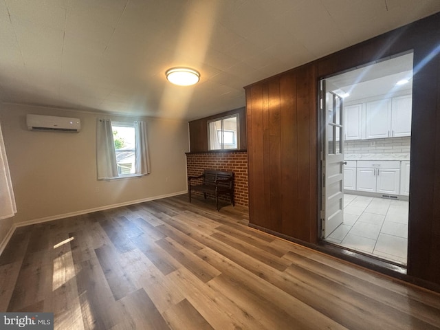 4714 Glenoak Rd, Hyattsville, MD 20784 - unfurnished living room featuring wood finished floors, baseboards, and a wall unit AC