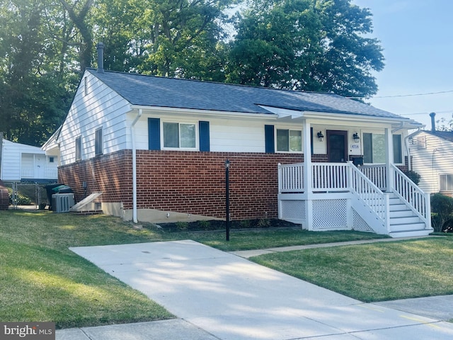 4714 Glenoak Rd, Hyattsville, MD 20784 - ranch-style home with roof with shingles, a front lawn, brick siding, central air condition unit, and covered porch