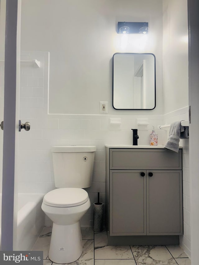4714 Glenoak Rd, Hyattsville, MD 20784 - bathroom with vanity, marble finish floor, a wainscoted wall, and toilet