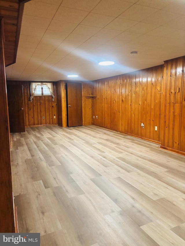 4714 Glenoak Rd, Hyattsville, MD 20784 - basement featuring baseboards, wood walls, and wood finished floors