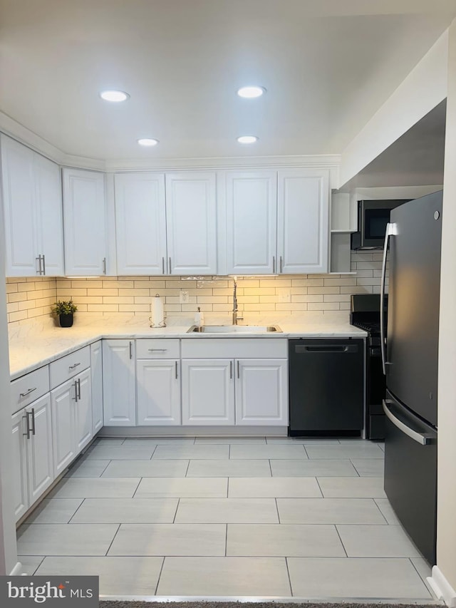 4714 Glenoak Rd, Hyattsville, MD 20784 - kitchen featuring white cabinets, stainless steel appliances, decorative backsplash, and a sink