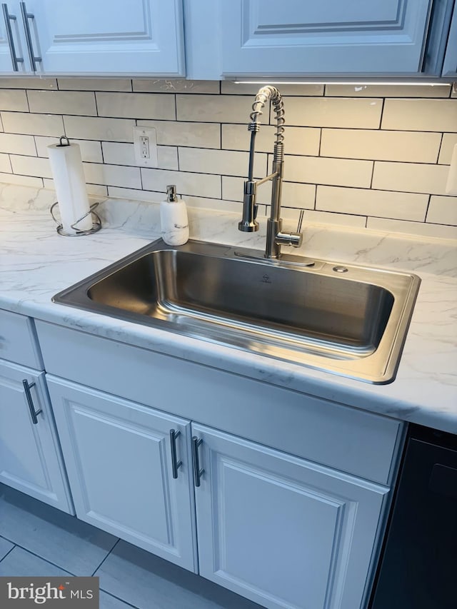 4714 Glenoak Rd, Hyattsville, MD 20784 - interior details with backsplash, light stone countertops, and a sink