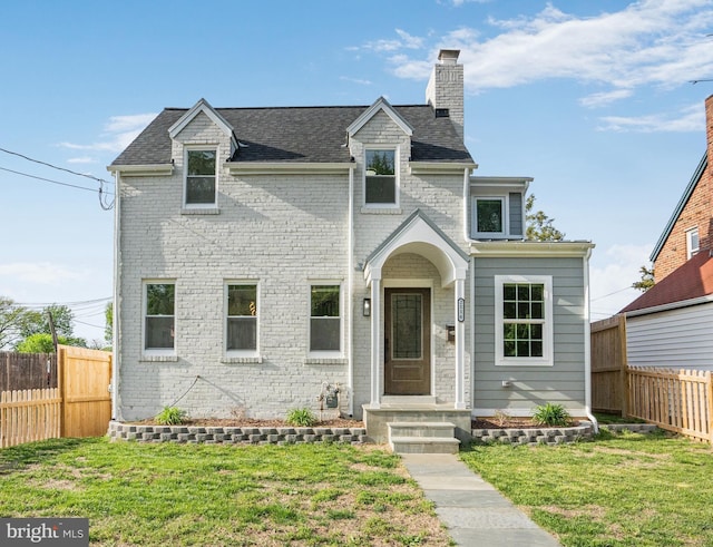 2116 R St NE, Washington, DC 20002 - view of front facade with roof with shingles, a front lawn, a chimney, fence, and brick siding