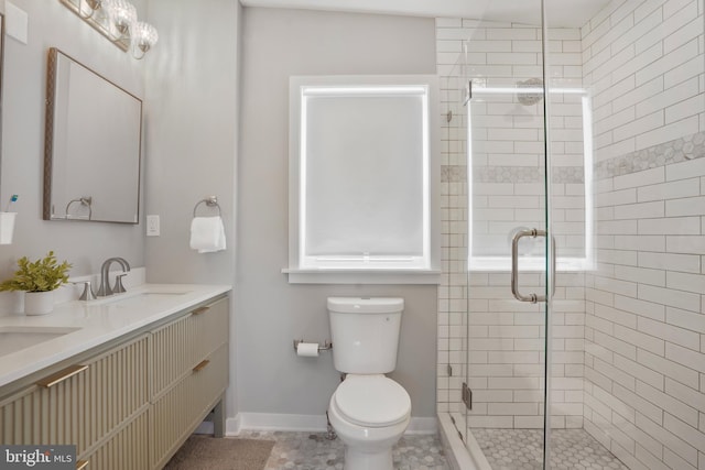2116 R St NE, Washington, DC 20002 - bathroom with a sink, toilet, a stall shower, double vanity, and baseboards