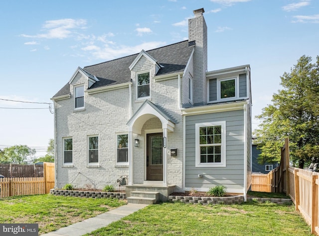 2116 R St NE, Washington, DC 20002 - view of front of house featuring a front lawn, a shingled roof, a fenced backyard, and a chimney