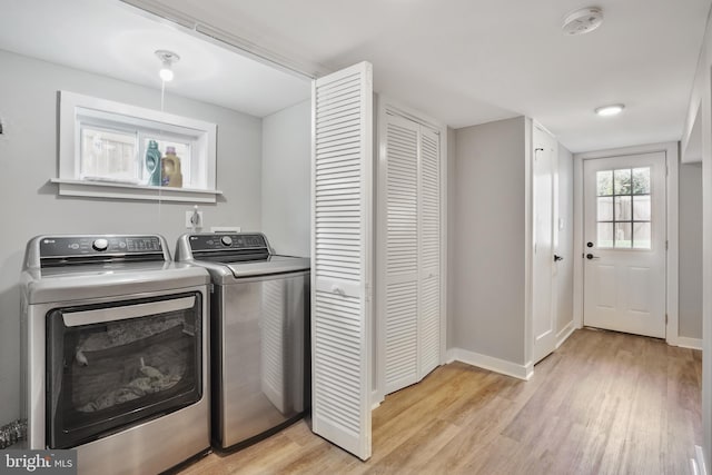 2116 R St NE, Washington, DC 20002 - clothes washing area featuring light wood-type flooring, washer and clothes dryer, laundry area, and baseboards