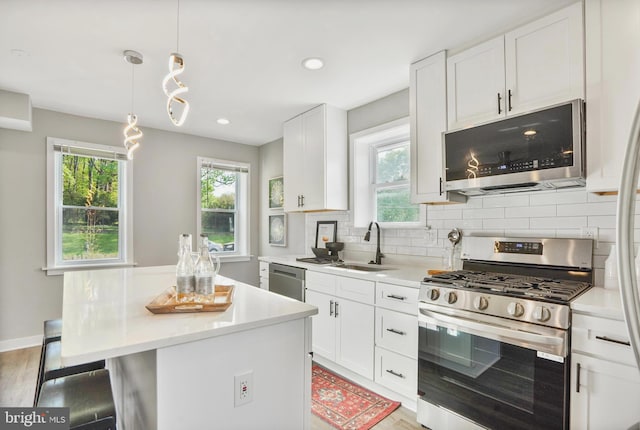 2116 R St NE, Washington, DC 20002 - kitchen with appliances with stainless steel finishes, light countertops, a kitchen island, and a sink
